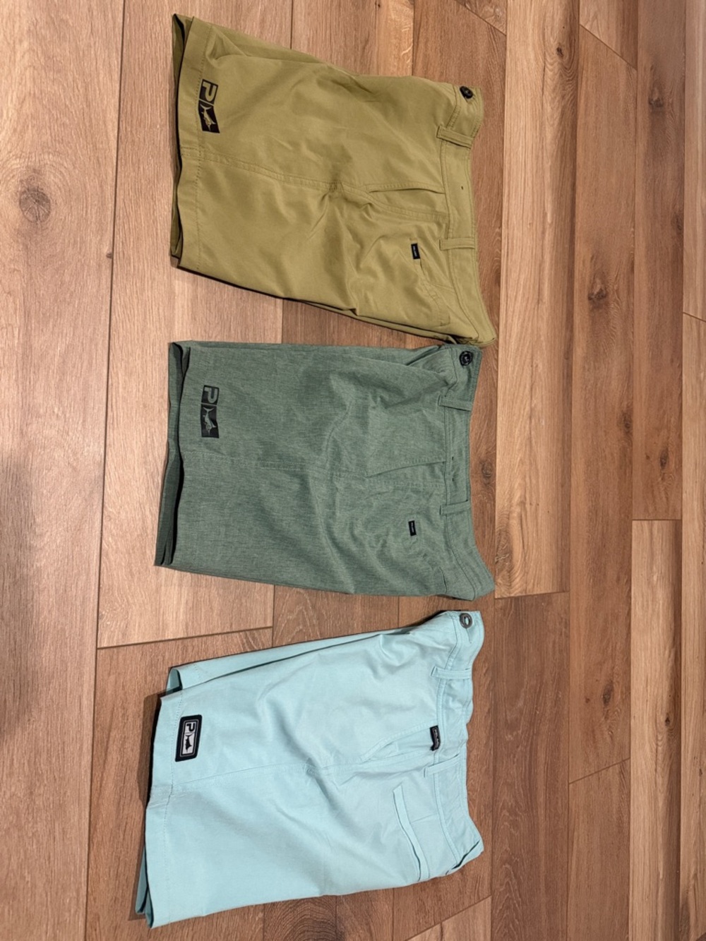27 youth Pelagic hybrid Shorts in Light Blue, Olive, and Sage